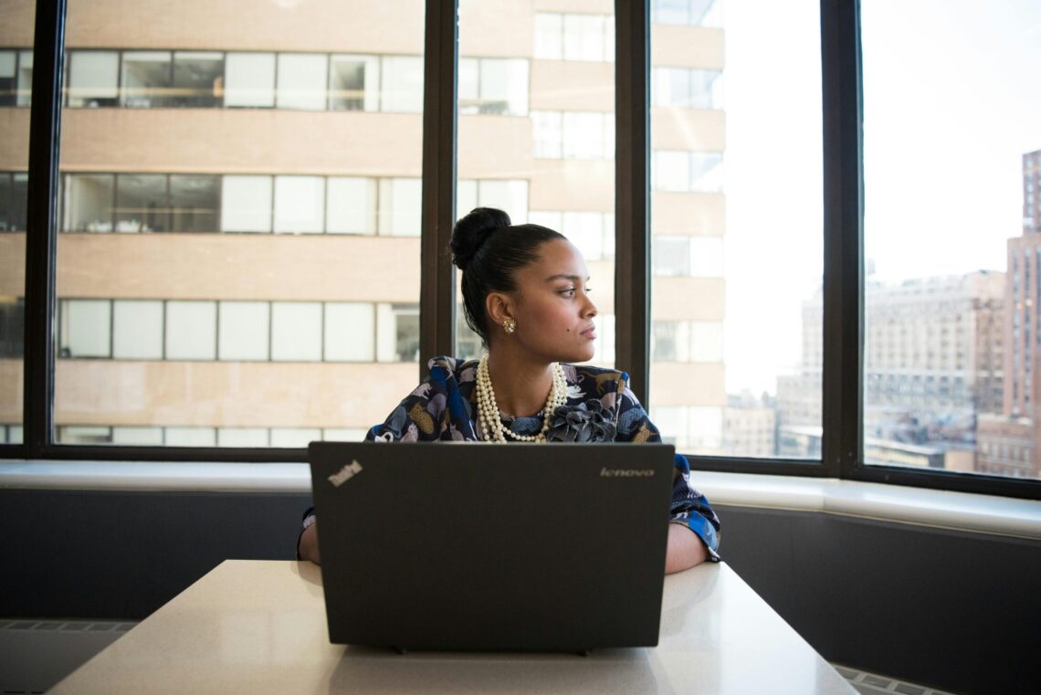 a women on her computer looking out the window