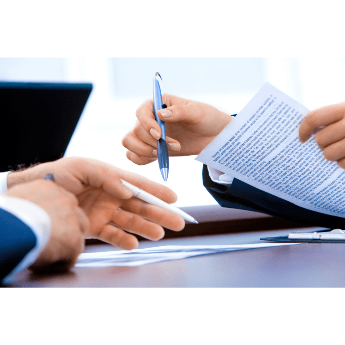 Hands shown signing papers and gesturing with pens.